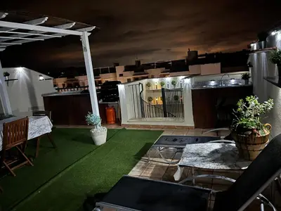 a balcony with a green floor and a table and chairs at PLAYA ALMENARA ATICO DUPLEX VISTAS AL MAR Y MONTAÑA WIFI,PISCINA a in Almenara