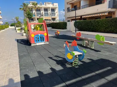 a playground with a toy train on a sidewalk at PLAYA ALMENARA ATICO DUPLEX VISTAS AL MAR Y MONTAÑA WIFI,PISCINA a in Almenara