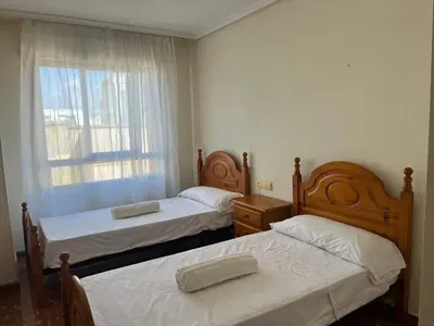 two beds in a small room with a window at Borriana Bonica in Burriana