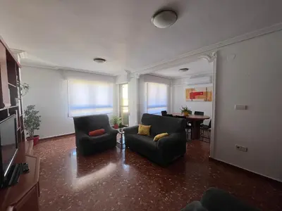 a living room with two chairs and a table at Borriana Bonica in Burriana