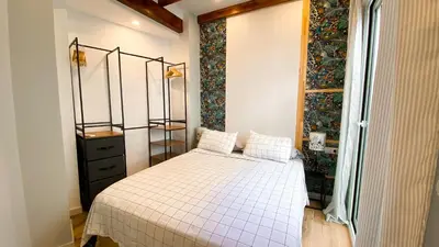 a bedroom with a bed in a room with a window at Apartamento Teo in Russafa in Valencia