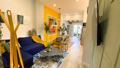 a living room with a blue couch and a table at Apartamento Teo in Russafa in Valencia