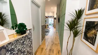 a hallway with green and white walls and a wooden floor at Apartamento Teo in Russafa in Valencia