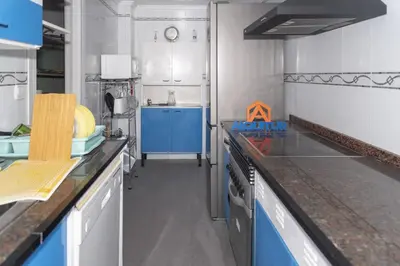 a kitchen with blue cabinets and a blue counter top at Torremar, D-13-25 in Cullera