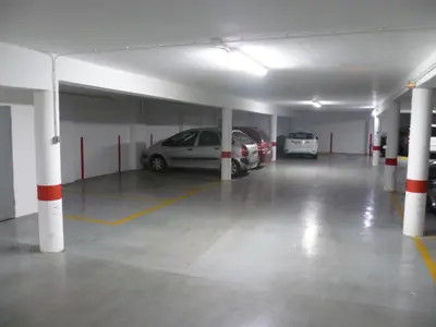 a parking garage with two cars parked in it at Torremar, D-13-25 in Cullera