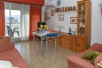 a living room with a table with flowers on it at Torremar, D-13-25 in Cullera