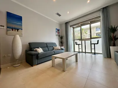 a living room with a couch and a table at Reinapart Patacona Beach 36 in Valencia