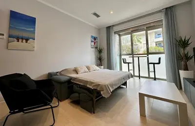 a room with a bed and a chair in it at Reinapart Patacona Beach 36 in Valencia