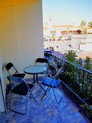 a patio with tables and chairs and a balcony at Great 4 bedrooms apartament in Puerto de Sagunto - Full Apartment - 120m2 in Puerto de Sagunto