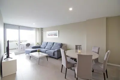 a living room with a couch and a table at Global Vacacional, Moderno apartamento con 2 terrazas y 3 habitaciones in Canet de Berenguer