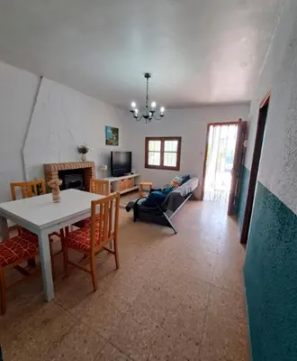 a living room with a table and chairs and a couch at Buganvilla in Valencia
