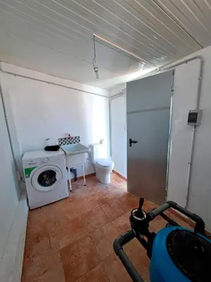 a bathroom with a washing machine and a toilet at Buganvilla in Valencia