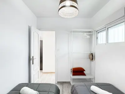 a white living room with a couch and a window at NUEVO, a 50 metros de la playa y con vistas al mar in Cullera
