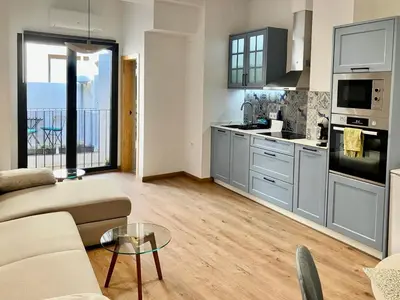 a living room with a couch and a kitchen at Sagunto Castillo 17 in Sagunto