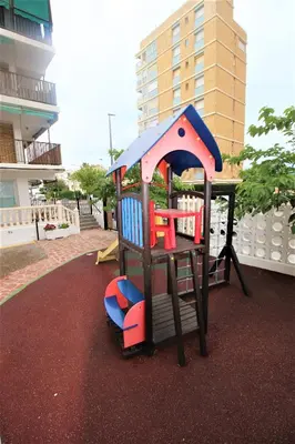 a playground with a play structure on a carpet at Sun & Sea Puebla in Puebla de Farnals