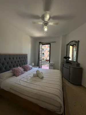 a bedroom with a large bed and a ceiling fan at Port Saplaya 3 habitaciones Valencia in Port Saplaya