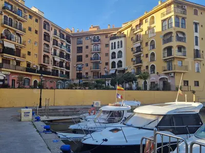 a group of boats docked in a harbor with buildings at Port Saplaya 3 habitaciones Valencia in Port Saplaya