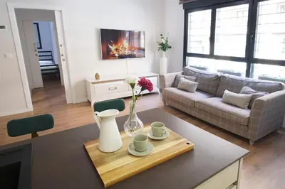 a living room with a vase of flowers on a table at Lujoso Hogar cerca del Casco Antiguo de la ciudad in Valencia