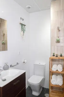 a bathroom with a white toilet and a sink at Lujoso Hogar cerca del Casco Antiguo de la ciudad in Valencia