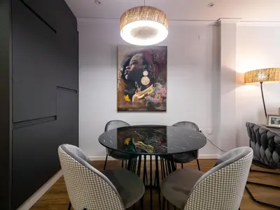 a dining room with a table and chairs and a painting at MD Iturbi Jardin Turia in Valencia