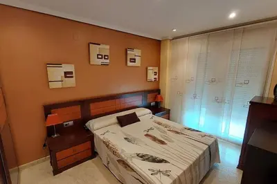 a bathroom with a toilet and a glass shower at Apartamento en urbanización lujo in Tavernes de Valldigna