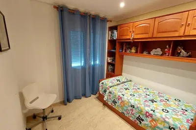 a white bathroom with a toilet and a shower at Apartamento en urbanización lujo in Tavernes de Valldigna