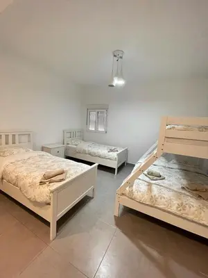 a room with three beds in a room at UIM Mediterraneo ATICO Hipanidad 1 WIFI in Puerto de Sagunto