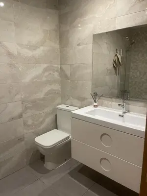 a bathroom with a white toilet and a sink at UIM Mediterraneo ATICO Hipanidad 1 WIFI in Puerto de Sagunto