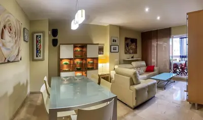 a living room with a table and a couch at Work and Rest Away From Home in Paterna