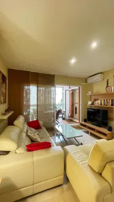 a living room with a white couch and a television at Work and Rest Away From Home in Paterna