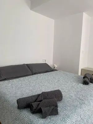 a bedroom with a bed with a towel on it at Arts & Sciences Rooms - Valencia Authentic Urban Parklife - VLC Urban Rental in Valencia