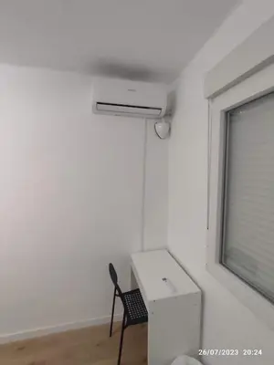 a room with a chair and a desk and a window at Arts & Sciences Rooms - Valencia Authentic Urban Parklife - VLC Urban Rental in Valencia