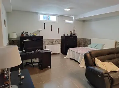 a living room with a couch and a bed at Villa de lujo frente al mar in Barrio-Mar