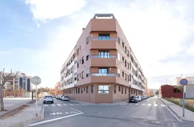 an apartment building on a street with cars parked at Apartamento Margalló con Garaje in Xilxes