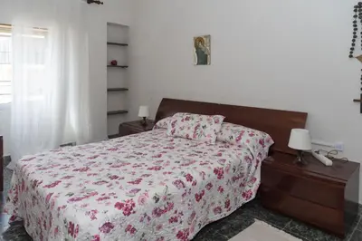 a bedroom with a bed with a red and white comforter at El Raco, A-8-16 in Cullera