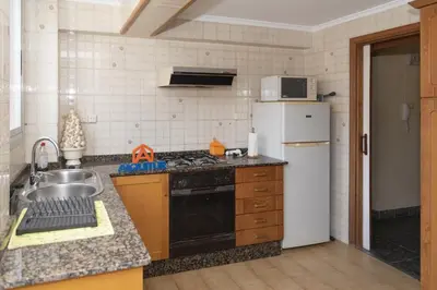 a kitchen with a sink and a refrigerator at El Raco, A-8-16 in Cullera