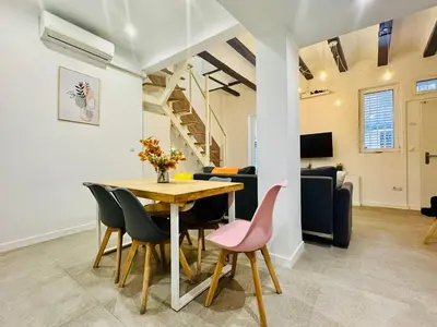 a dining room and living room with a table and chairs at Design & Stylish House in the CENTER of Valencia in Valencia