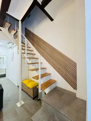 a staircase in a house with a yellow bed underneath it at Design & Stylish House in the CENTER of Valencia in Valencia
