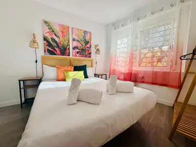 a bedroom with a large white bed with colorful pillows at Design & Stylish House in the CENTER of Valencia in Valencia