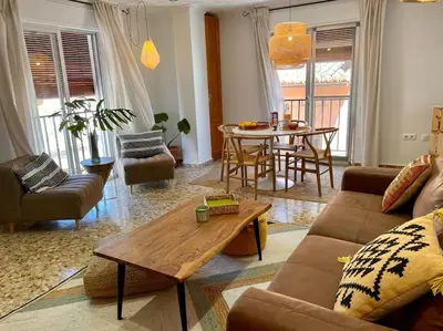 a living room with a couch and a table at Mountain Retreat with stunning terrace views in Pedralba