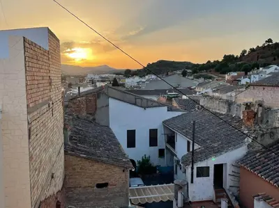 a view of a city at sunset with buildings at Mountain Retreat with stunning terrace views in Pedralba
