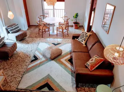 a living room with a couch and a table at Mountain Retreat with stunning terrace views in Pedralba