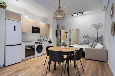 a kitchen and living room with a table and chairs at Marina Beach Apartments in Valencia