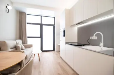 a kitchen and living room with a table and a sink at Maritim 1 by Concept Flats in Valencia