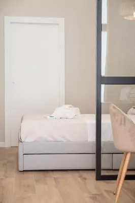 a bedroom with a bed and a chair at Maritim 1 by Concept Flats in Valencia