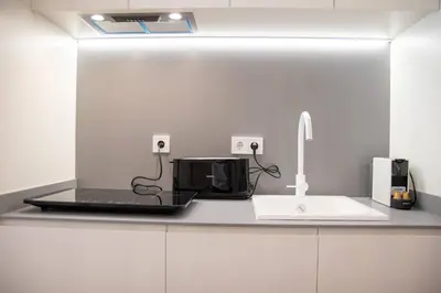 a kitchen counter with a microwave and a sink at Maritim 1 by Concept Flats in Valencia