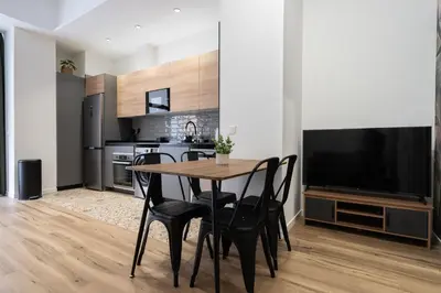 a kitchen and dining room with a table and chairs at Beach Apartments Valencia in Valencia