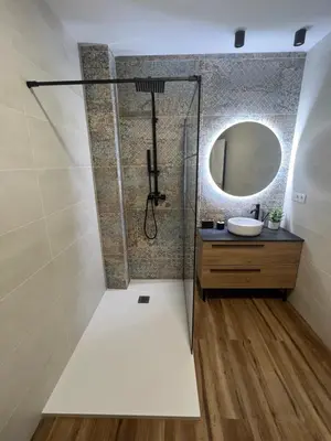 a bathroom with a shower with a sink and a mirror at Beach Apartments Valencia in Valencia