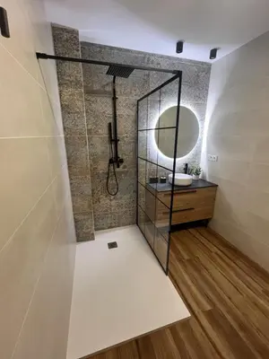 a bathroom with a shower with a sink and a mirror at Beach Apartments Valencia in Valencia