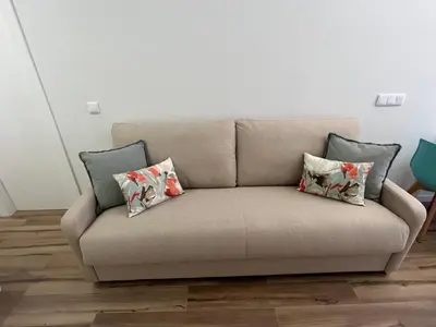 a couch with four pillows on it in a room at Beach Apartments Valencia in Valencia